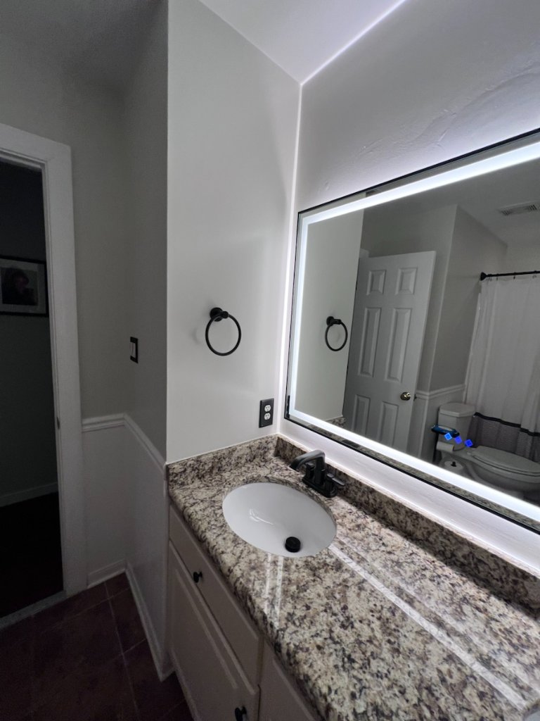 Backlit mirror and bathroom hardware installation in Jacksonville, FL by Heylo Home