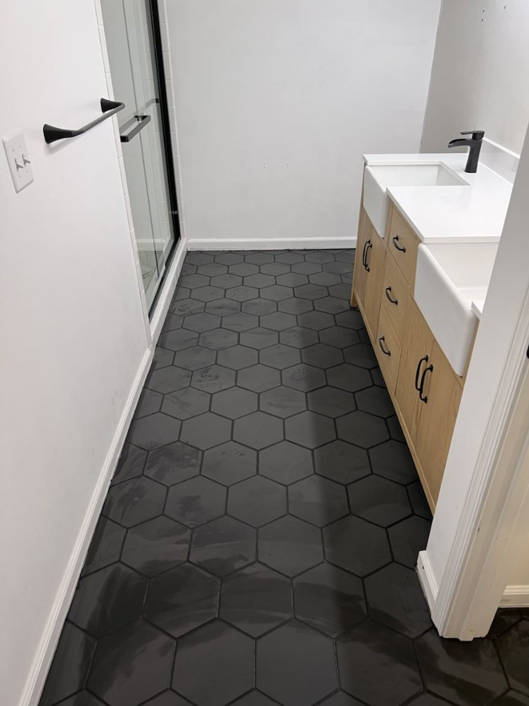 Black hex tile floor installation with bathroom vanity in Jacksonville, FL