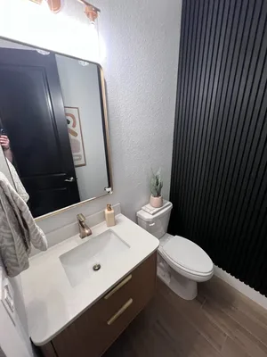 Finished bathroom update with floating vanity and accent wall in Jacksonville, FL