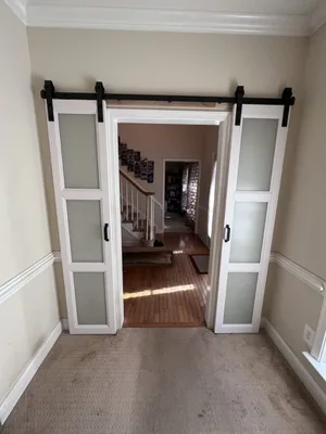 Barn door installation with black track hardware in Jacksonville, FL