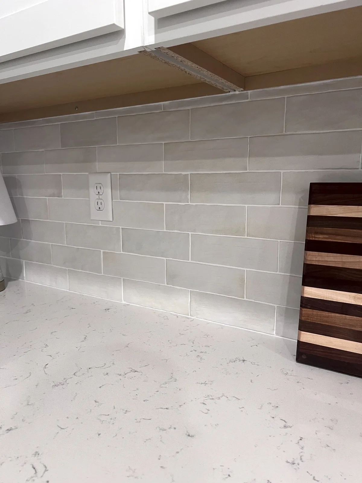 Finished white ceramic tile kitchen backsplash in Yulee, Florida