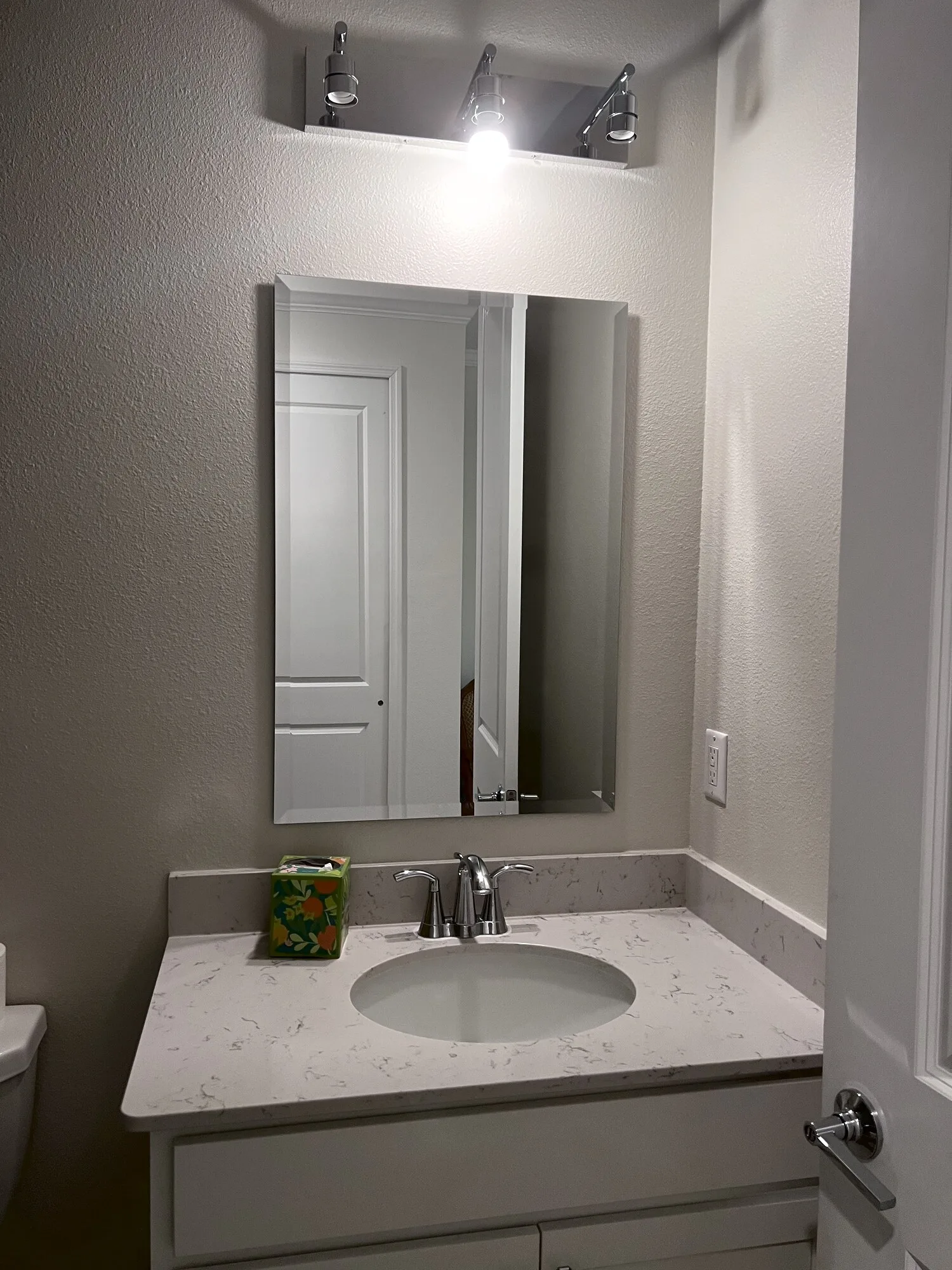 Bathroom mirror mounted above a vanity