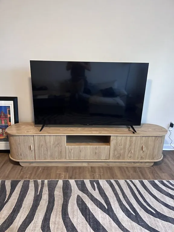 TV stand assembly with television set up in a Jacksonville, FL home