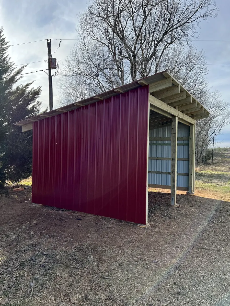 After photo 1 of the open-front storage shed