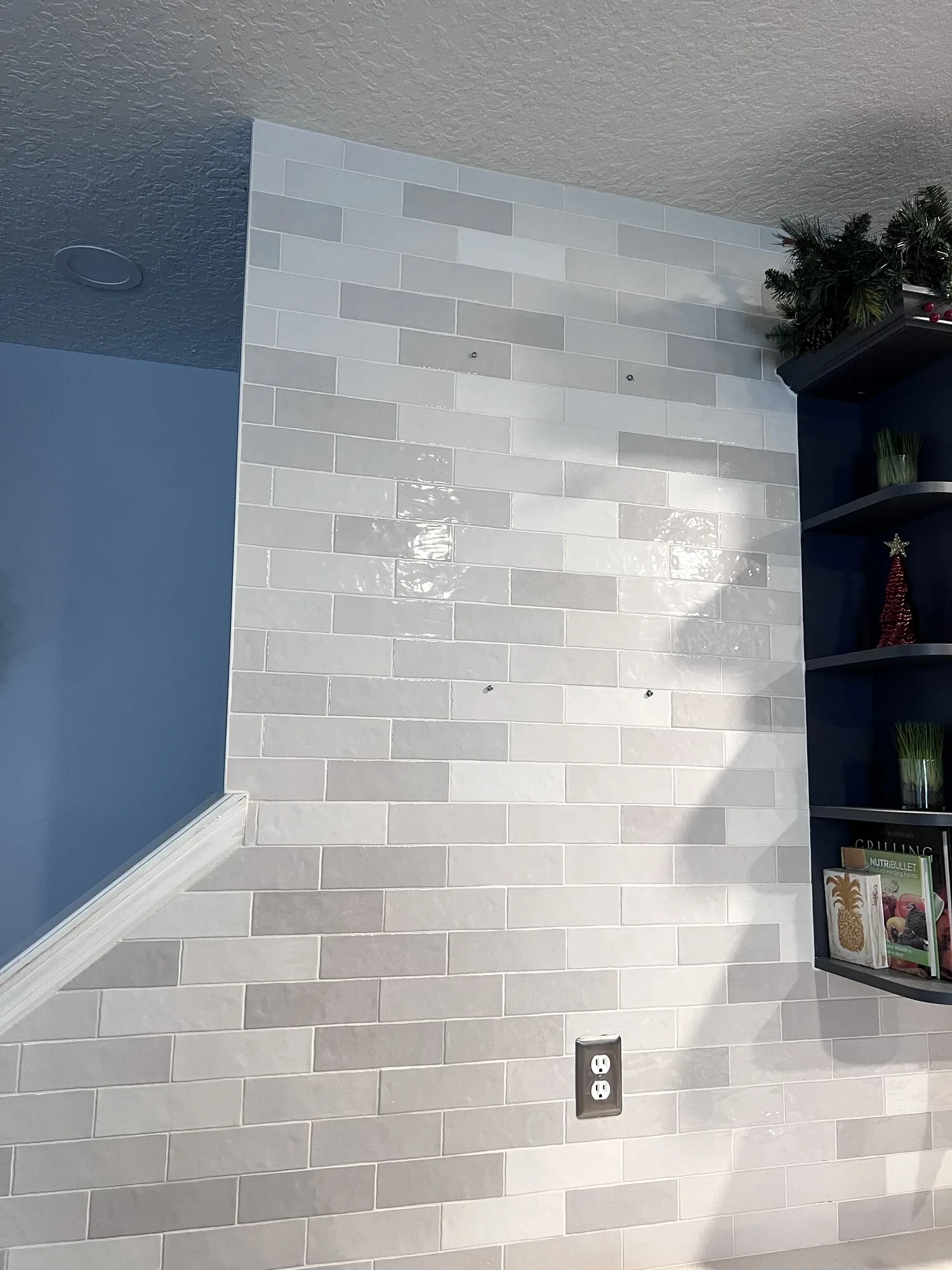 Tiled bathroom wall before decorative mirrors were installed
