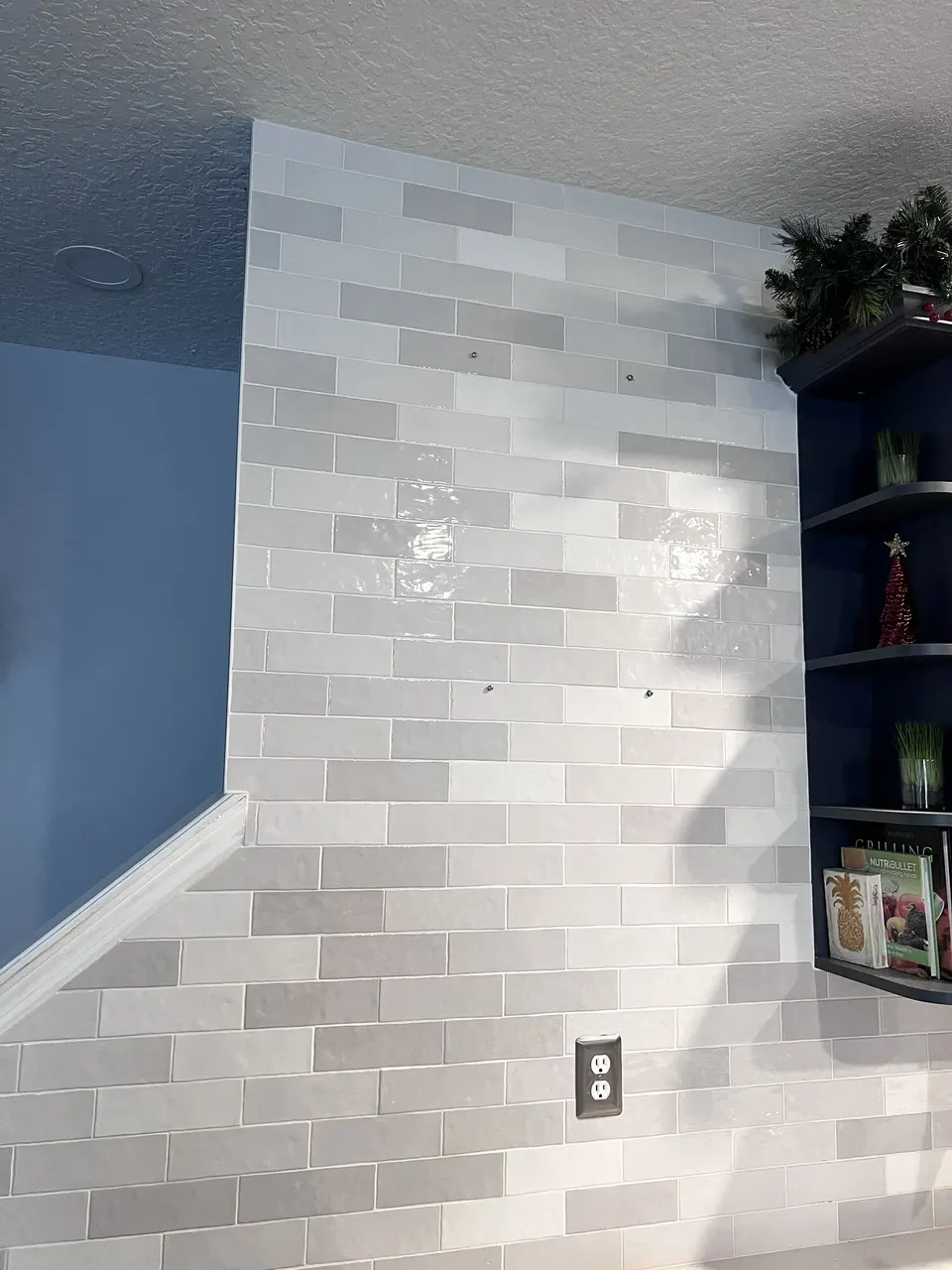 Tiled bathroom wall before decorative mirrors were installed