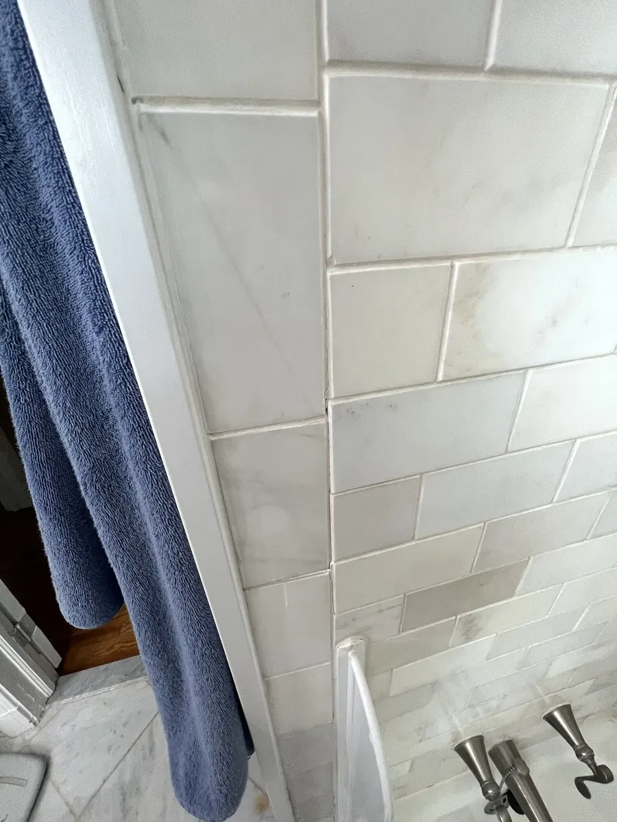 Before photo 2 of the marble-look tub surround