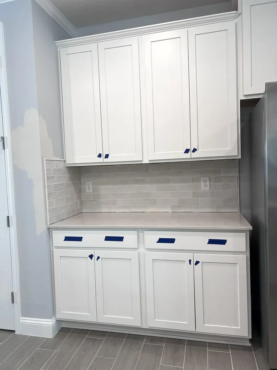 Backsplash tile being fitted around outlets and switches