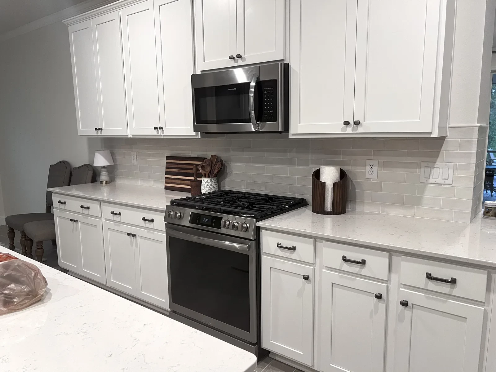 Completed full-height tile backsplash and kitchen counters
