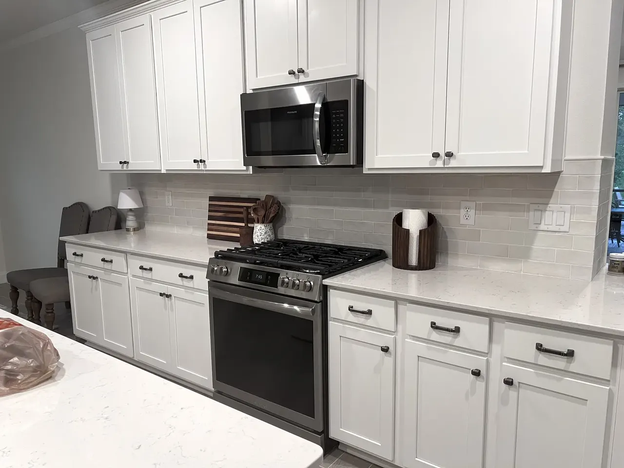 Completed full-height tile backsplash and kitchen counters