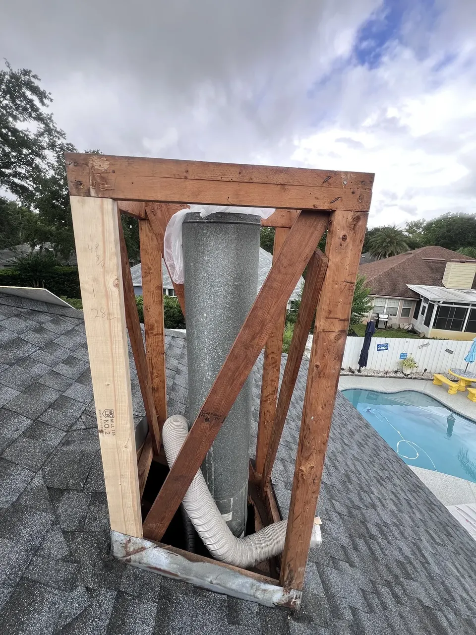 Replacement framing and sheathing progressing around the chimney