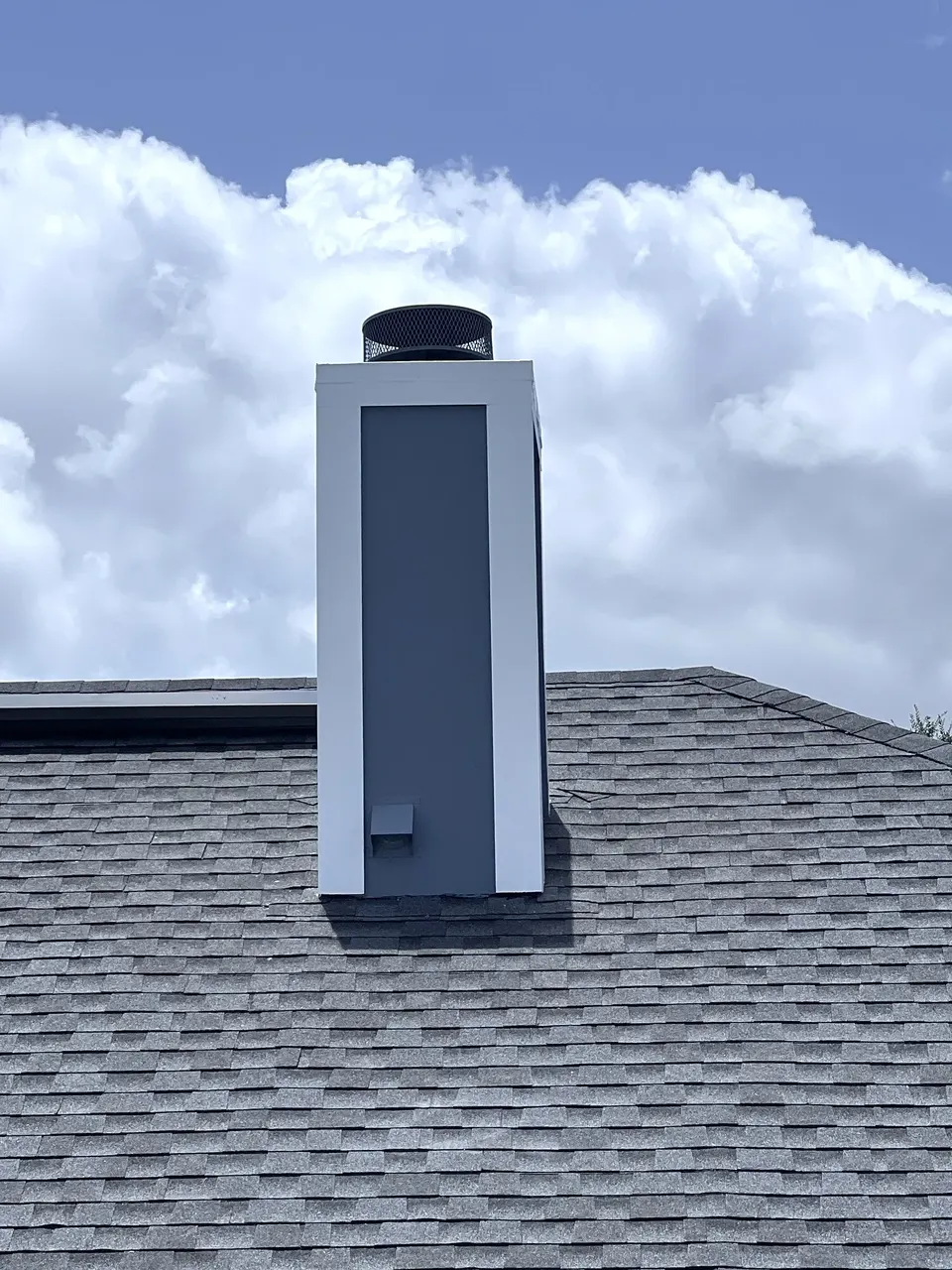 Rebuilt and painted chimney exterior after the repair