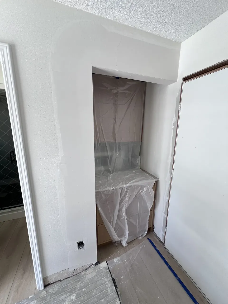 New drywall fitted around the built-in cabinetry