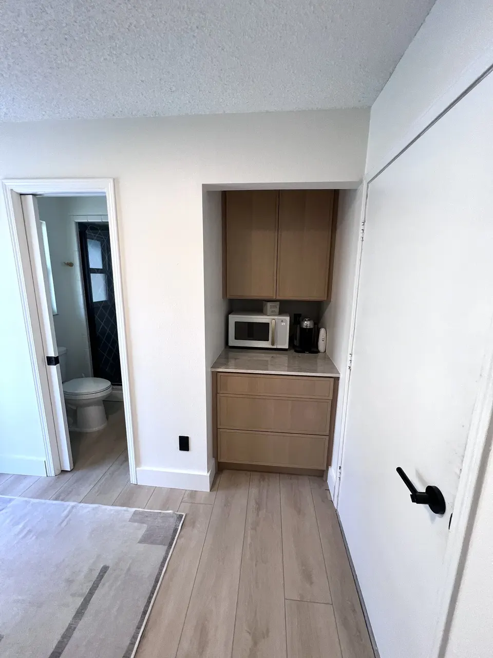 Completed wall finish meeting the coffee-bar cabinetry