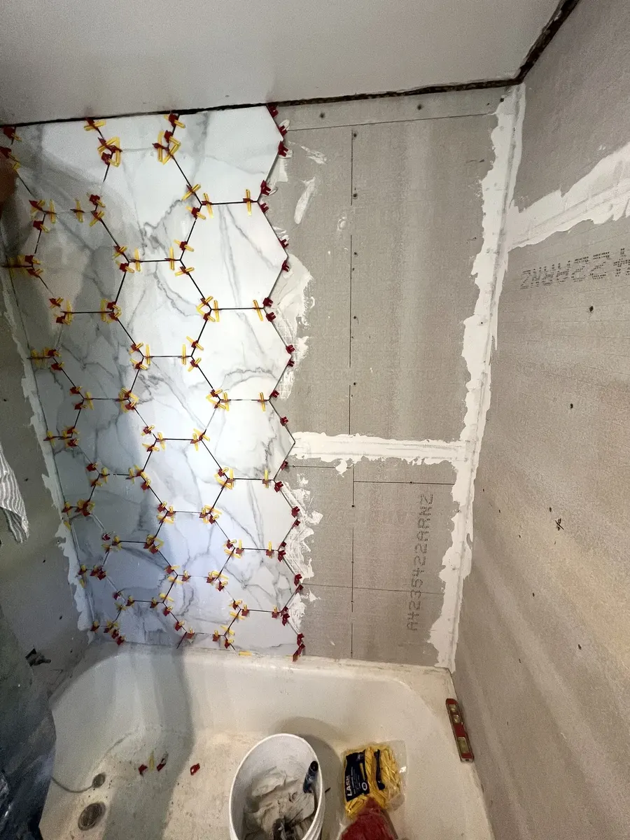 During photo 2 of the marble-look tub surround