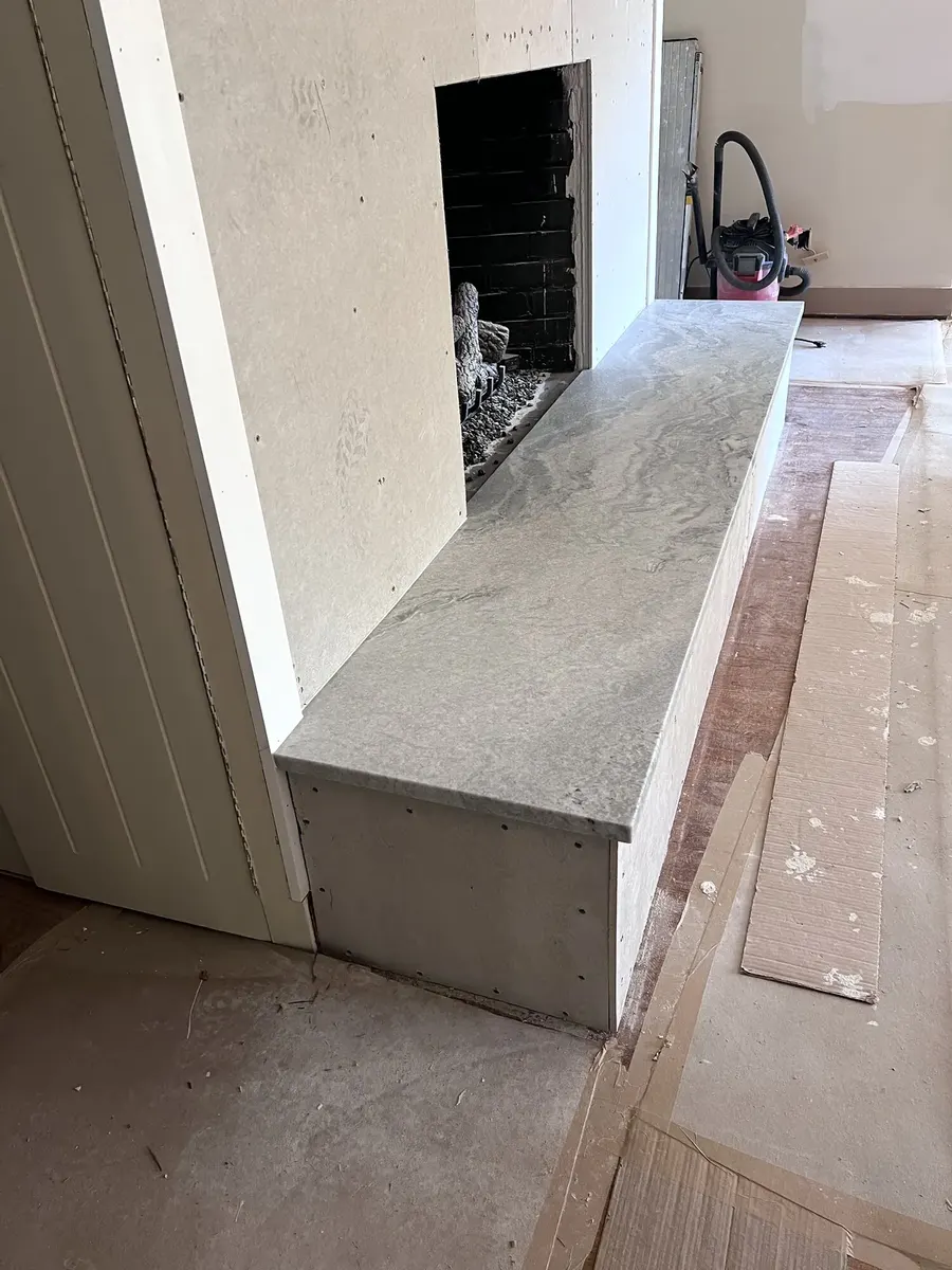 During photo 3 of the stone ledger fireplace