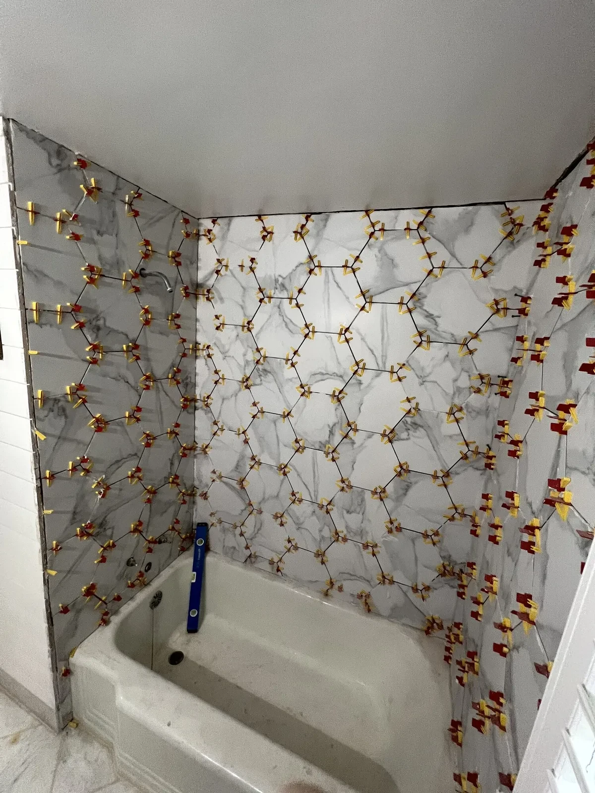 During photo 3 of the marble-look tub surround