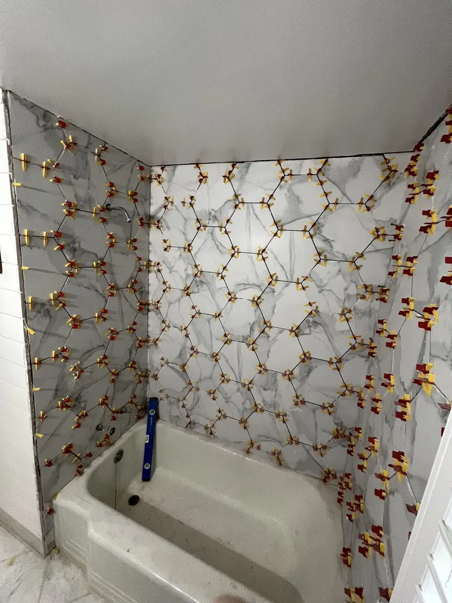 During photo 3 of the marble-look tub surround