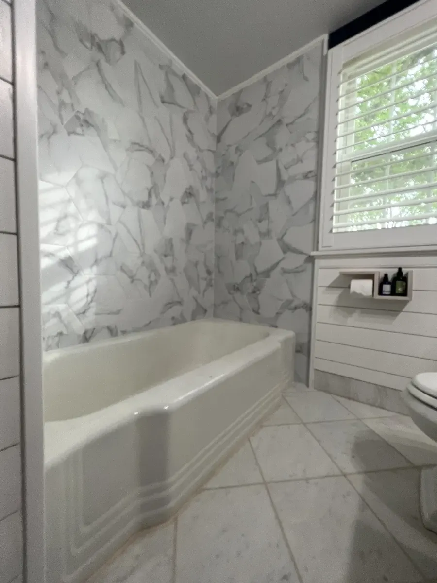 During photo 4 of the marble-look tub surround