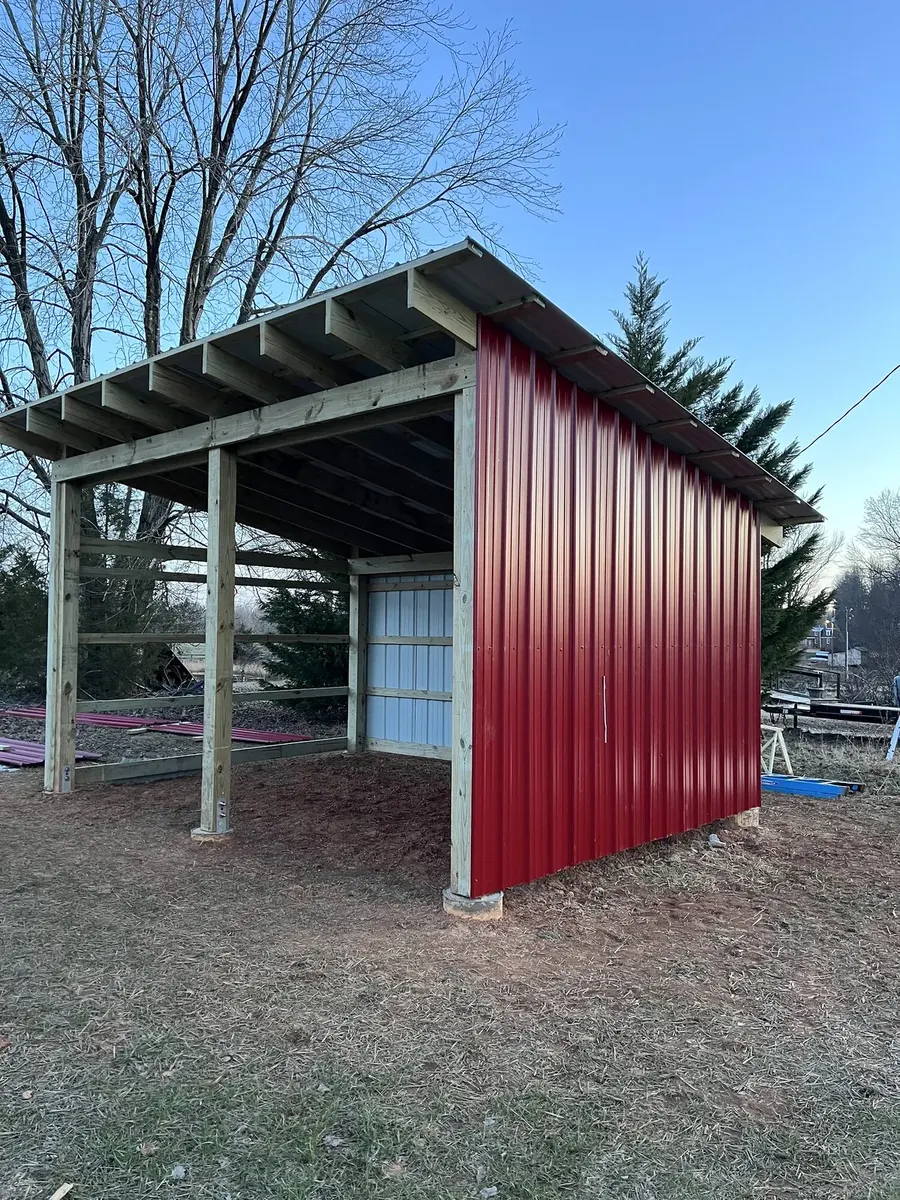 During photo 5 of the open-front storage shed