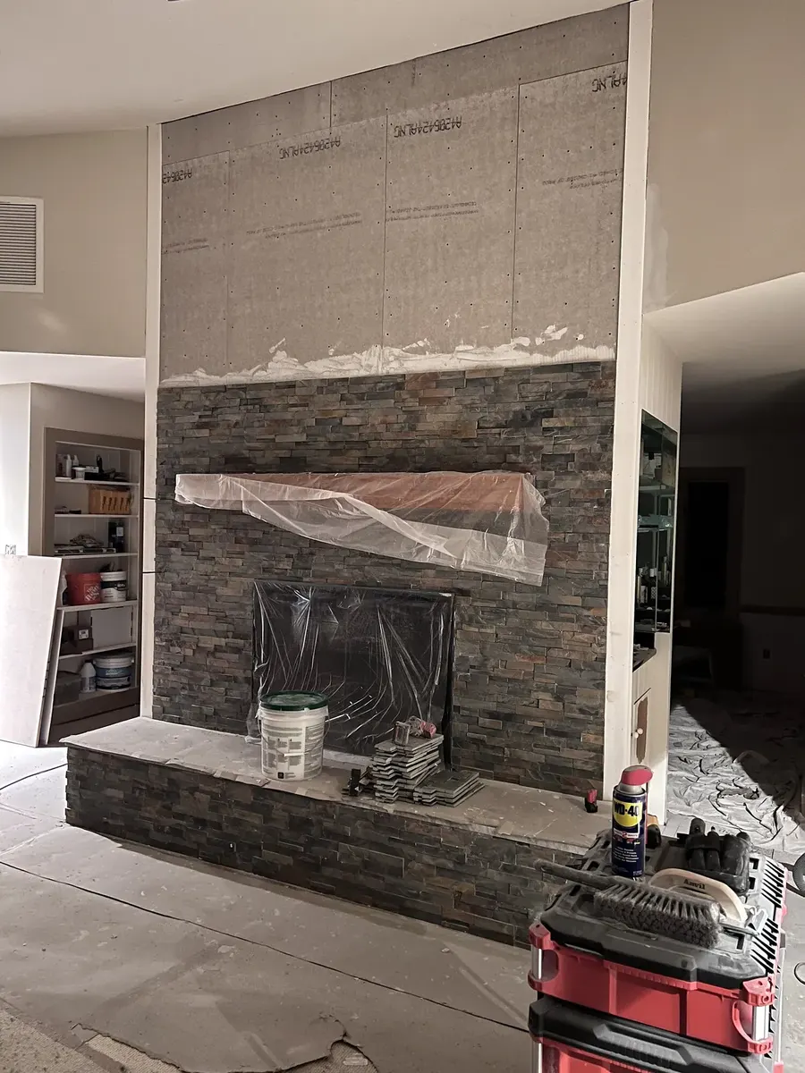 During photo 5 of the stone ledger fireplace
