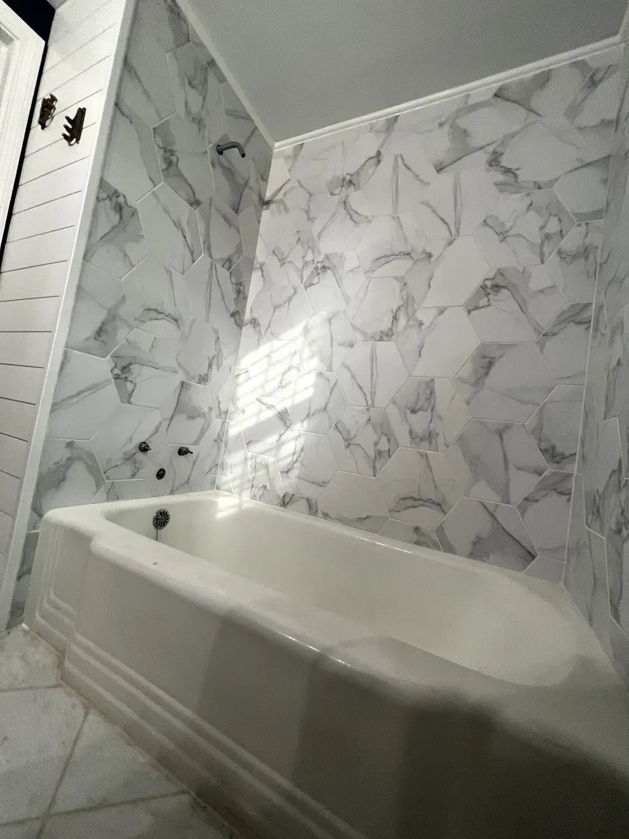 During photo 5 of the marble-look tub surround