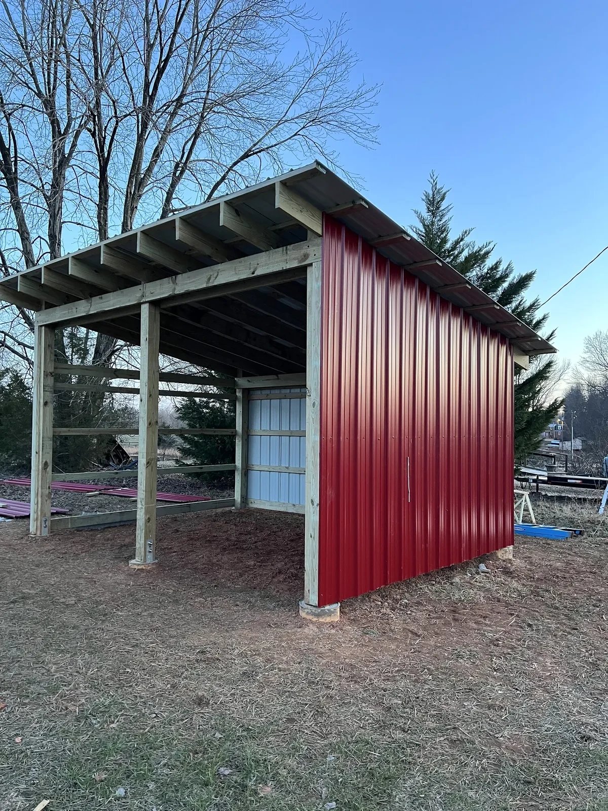 During photo 5 of the open-front storage shed