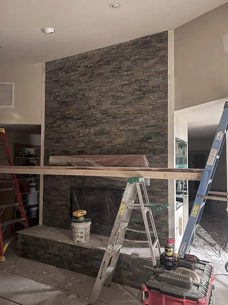 During photo 6 of the stone ledger fireplace