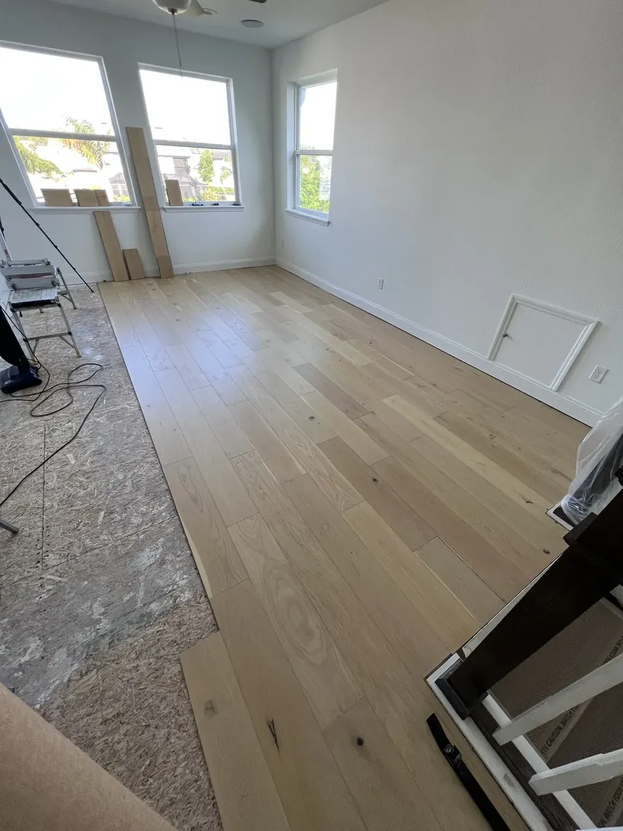 Flooring installation continuing through the upstairs living space
