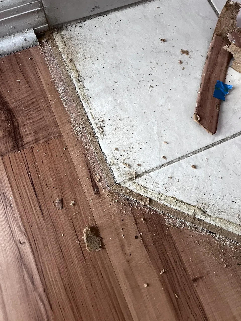 Flooring transition pieces being fitted around a fireplace