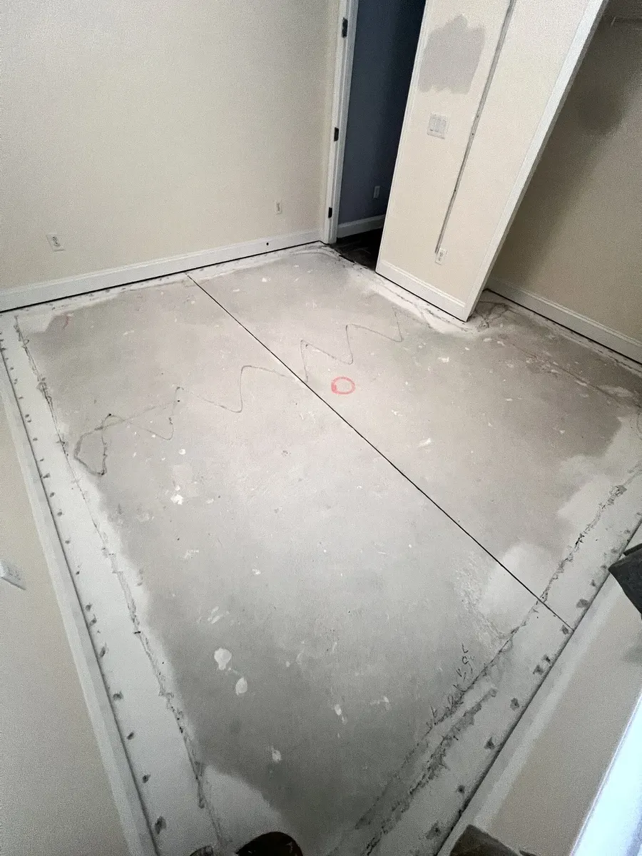 LVP flooring installation progressing across a bedroom