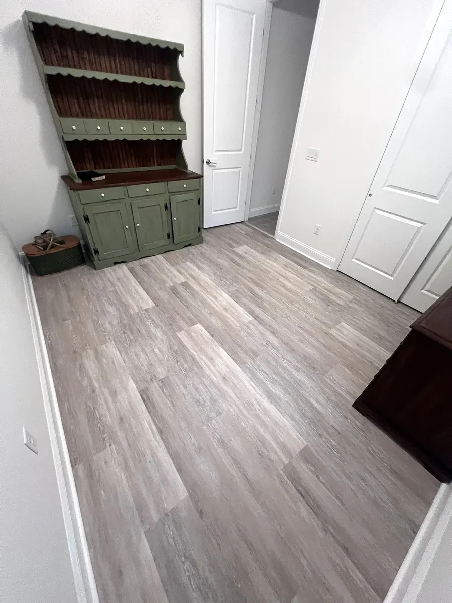Completed LVP floor in a furnished bedroom