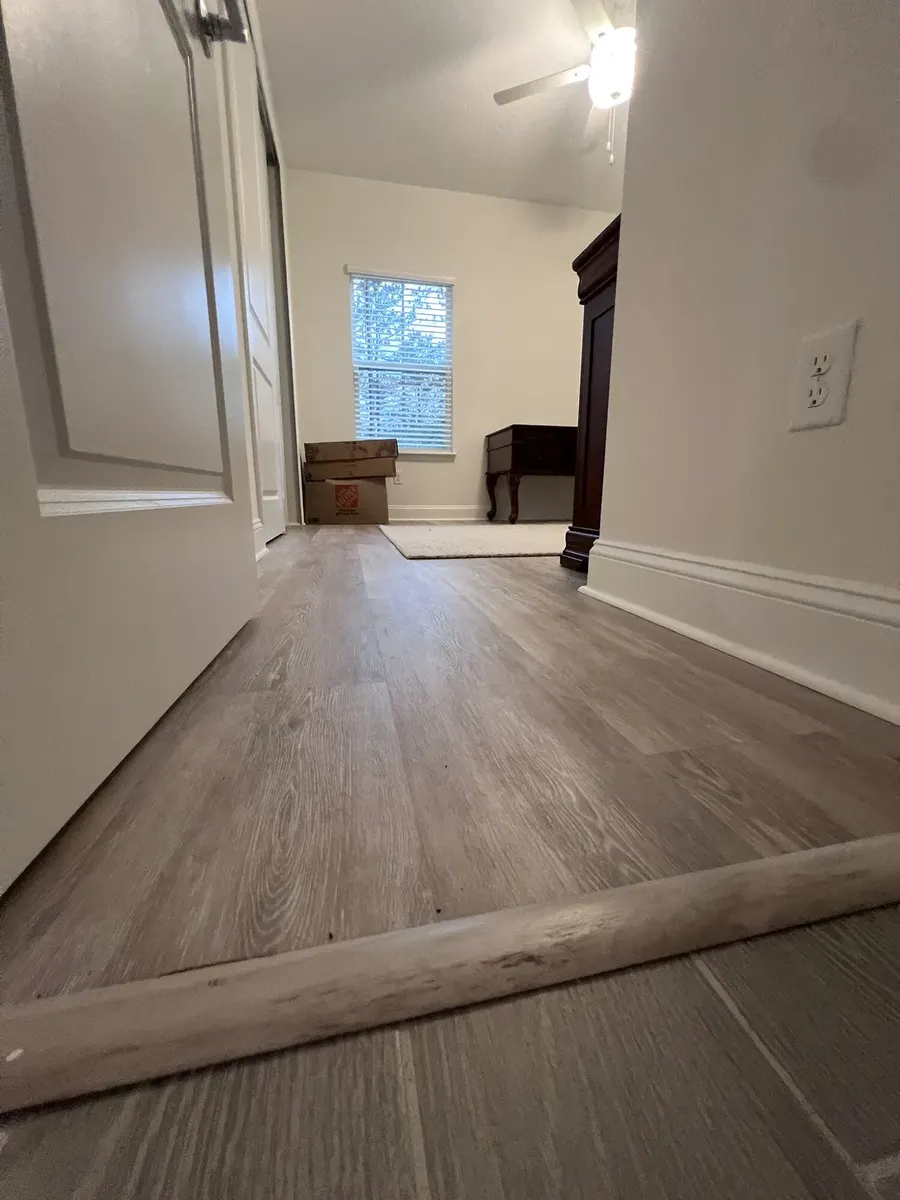 Wide view of a completed bedroom LVP floor