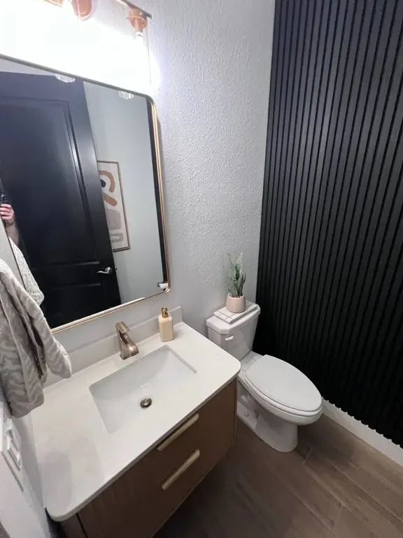 Bathroom update with floating vanity, mirror, fluted accent wall, and trim