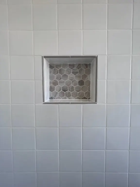 Jacksonville shower remodel with tiled walls and built-in niche