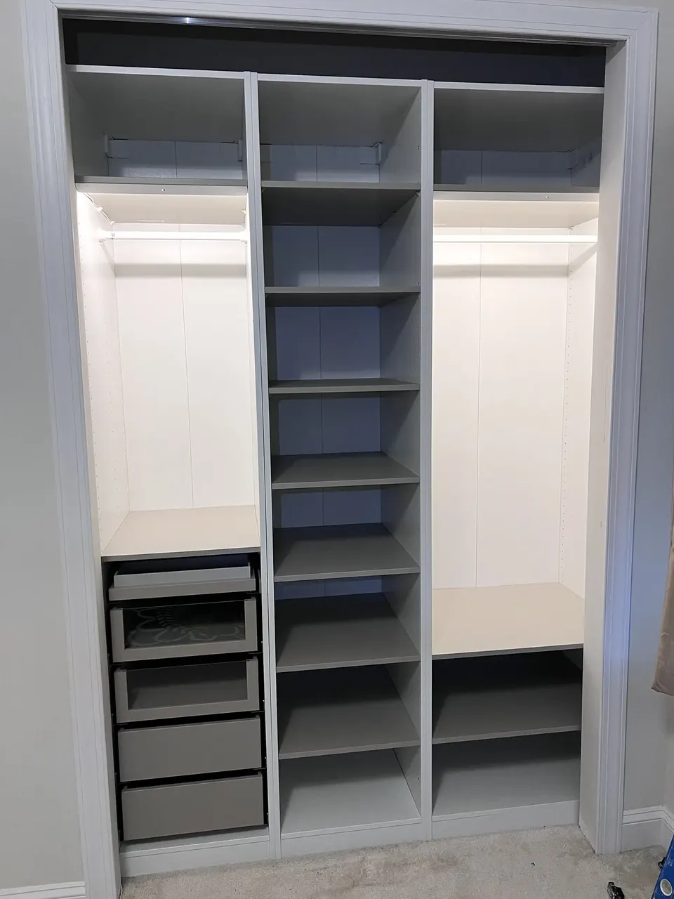 Completed IKEA PAX wardrobe with drawers, shelving, and lighting in St. Johns, Florida
