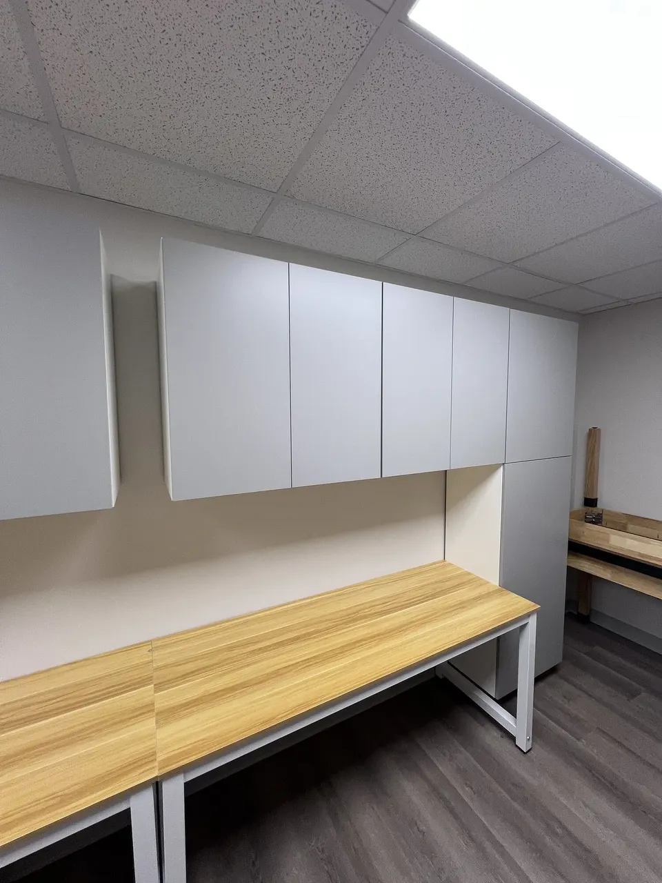 Completed white wall cabinet run above a work surface