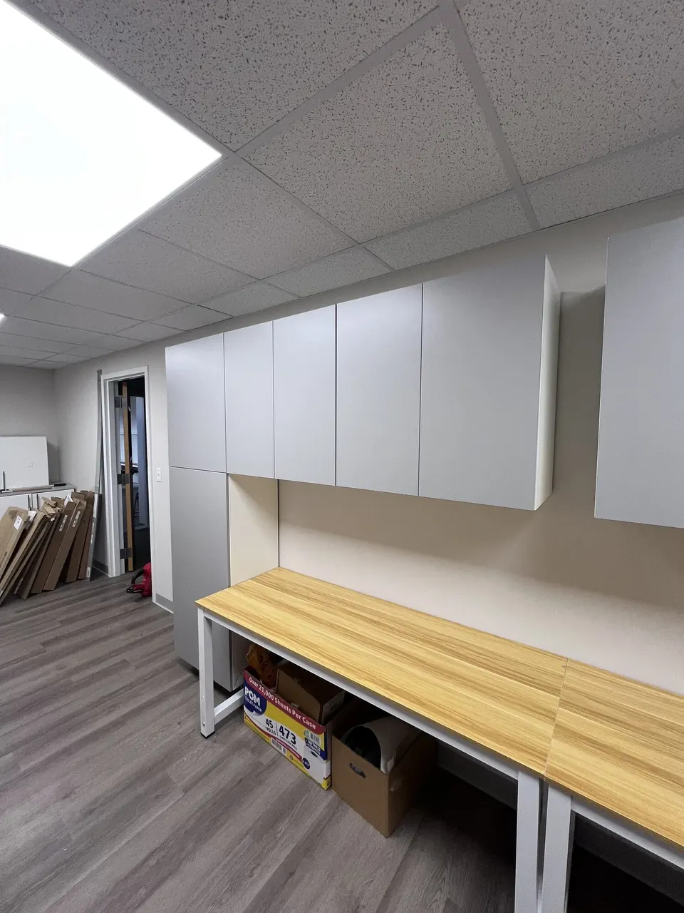 Finished wall cabinets viewed from the end of the room