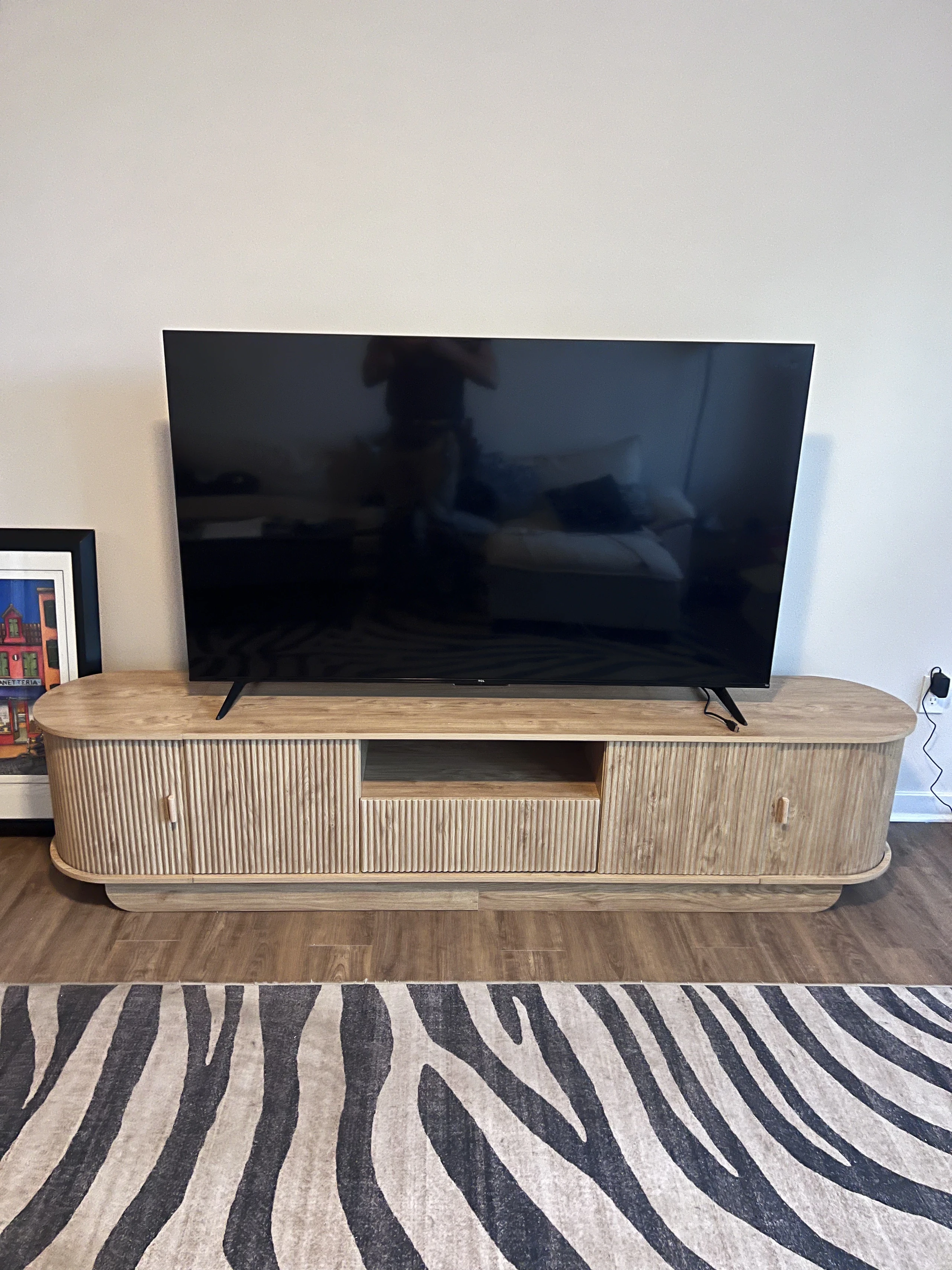 TV stand assembly with television set up in a Jacksonville, FL home