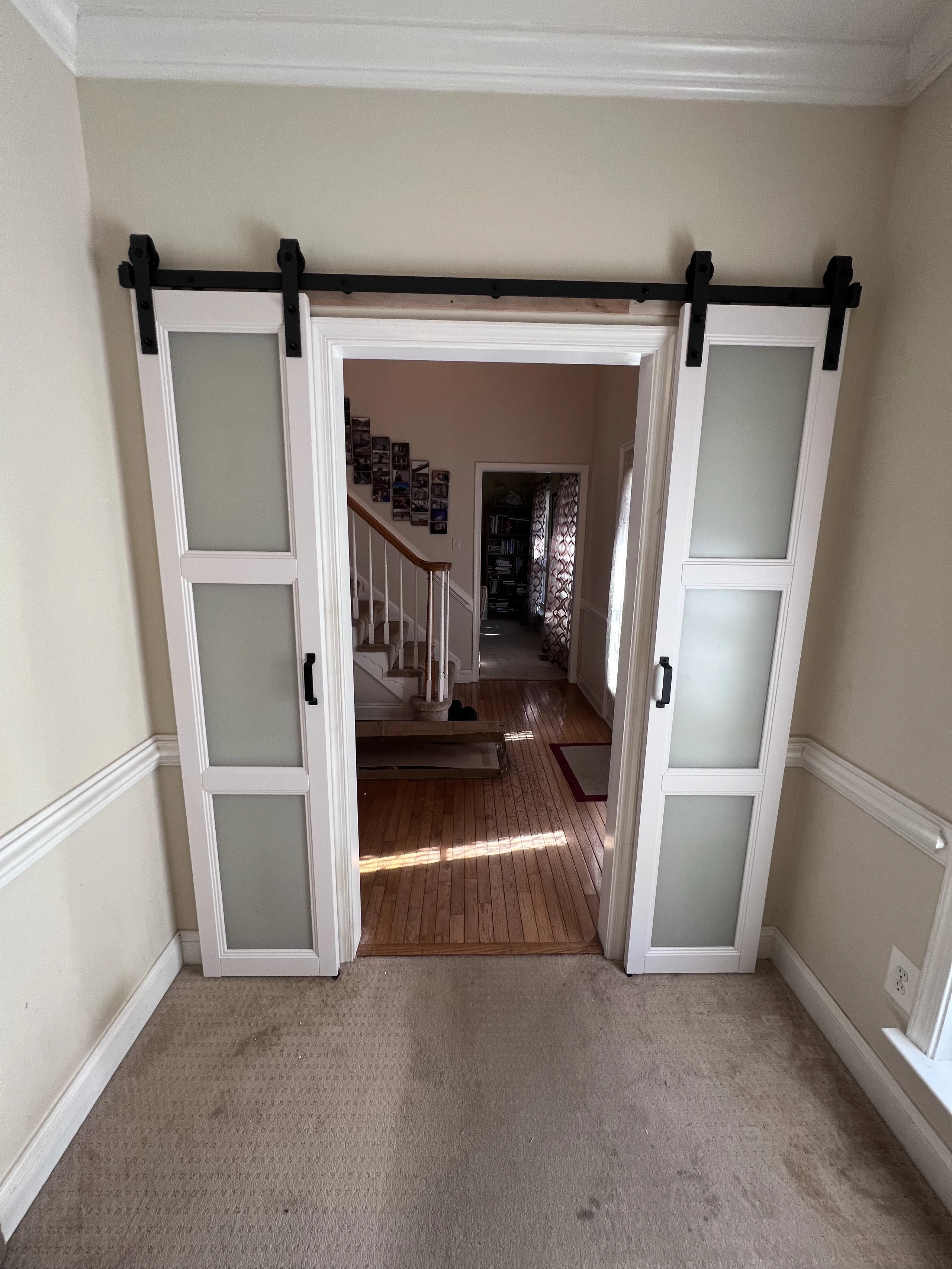 Barn door installation with black track hardware in Jacksonville, FL