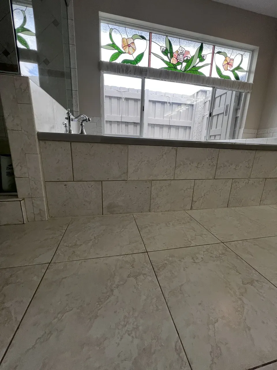 Finished tiled tub access panel aligned with the surrounding tile