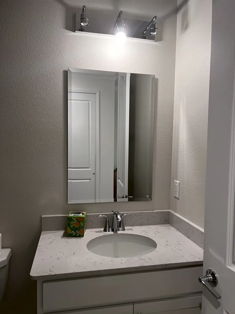 Bathroom mirror mounted above a vanity