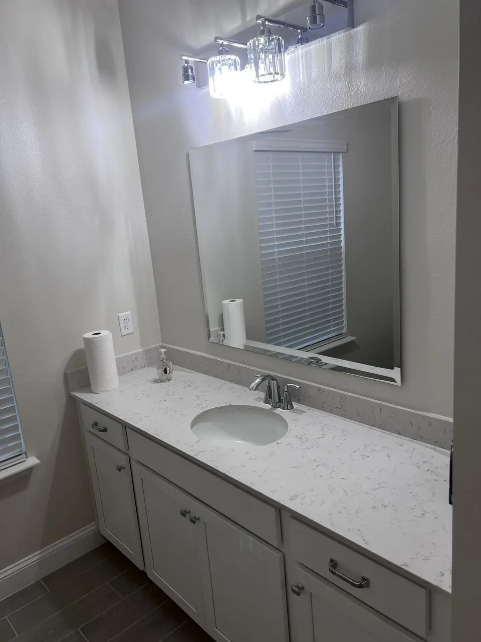 Finished mirror and cabinet pull installation