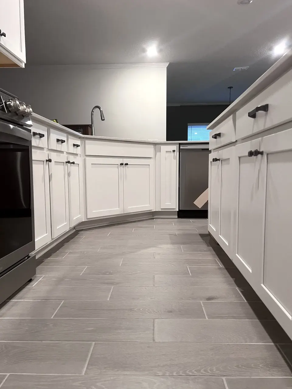New cabinet pulls aligned across the kitchen drawers